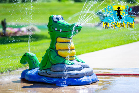 Alligator splash pad water play feature spraying streams of water, fun backyard sprinkler for kids.