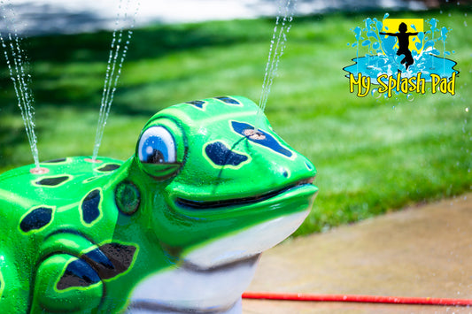 Frog Day Care Fun Splash Pad Feature – bright green frog water play structure with sprinkler jets spraying upward.