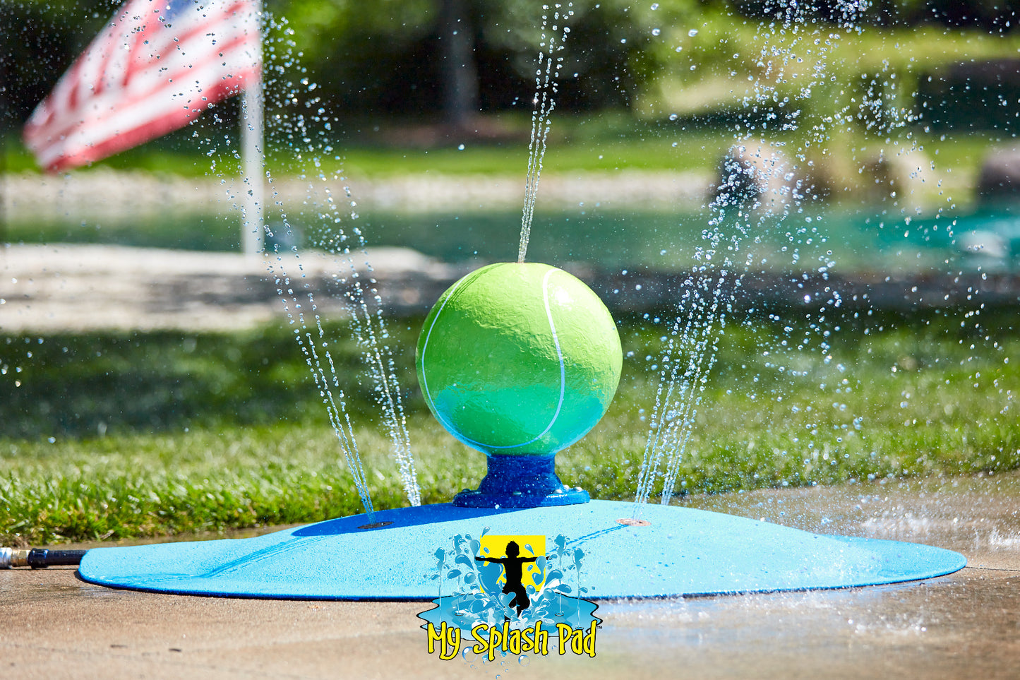 Tennis Ball Portable Water Play Feature by My Splash Pad spraying water streams from green tennis ball on blue base.