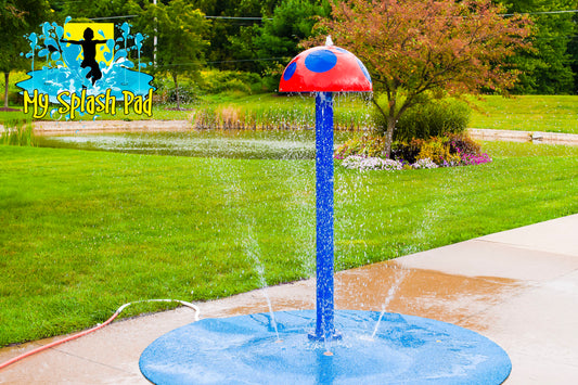 Mushroom Portable Splash Pad water play feature with tall blue stem and red mushroom cap spraying water, installed on backyard splash pad.