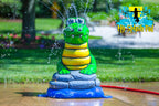 Alligator splash pad water play feature with bright green body and yellow belly, spraying water streams for kids’ outdoor fun.