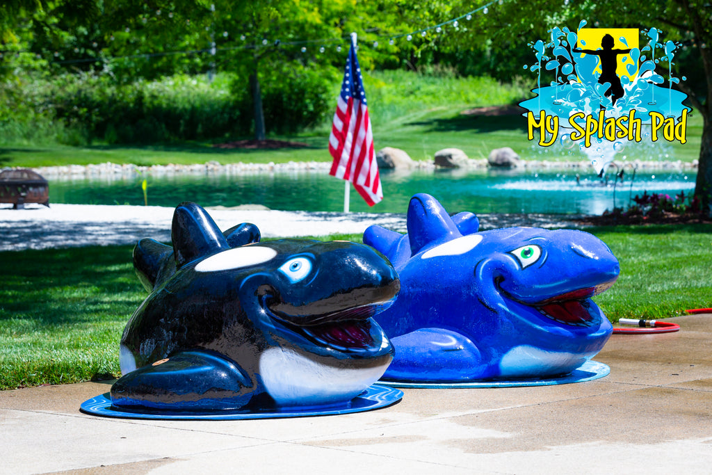 Dual Orca Mobile Spray and Play Features by My Splash Pad – black-and-white and blue orca-shaped splash pad play structures designed for children’s water fun.