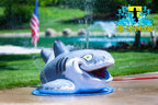 Shark-shaped mobile water play feature with a wide open mouth, green eyes, and detailed fins, designed for children’s splash pad play.